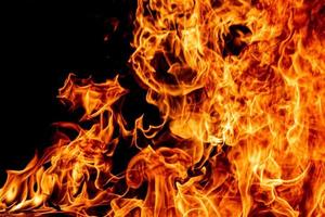 Fire flame texture. Burning material backdrop. Burn effect pattern. Blaze and torch wallpaper. Heat and haze backdrop. photo