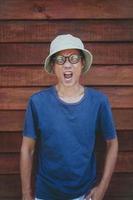 asian man wearing clothes hat acting wow with funny face photo
