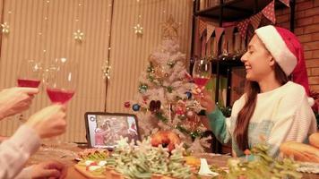 Family chatted and celebrated happily via internet webcam by tablet during Christmas festival holidays and New Year's meal, cheerful, enjoy eating foods in dining room special decorating for a party. video