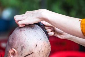 Shaving his head before becoming a monk photo