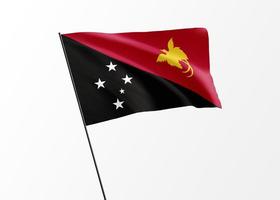 Papua New Guinea flag flying high in the isolated background Papua New Guinea independence day. World national flag collection photo