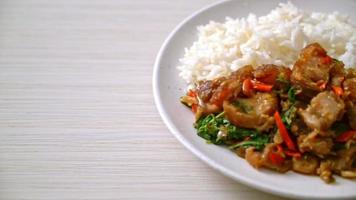 stir-fried crispy belly pork with basil and chili topped on rice video