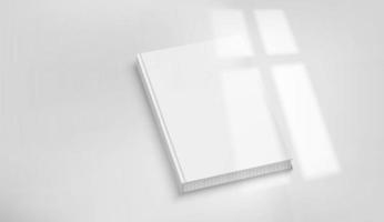 White book on a tabke with light of the window shadow overlay. Realistic vector mockup