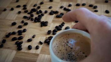 mão colocando uma xícara de café fresco preto video