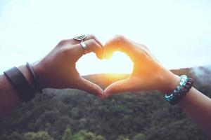 Asian Women and men lover travel relax in the holiday. Hand-made heart photo