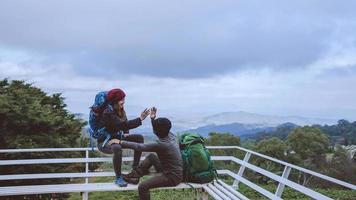 Asian couples travel nature on the mountains in winter.Travel relax. Natural touch countryside at doi inthanon in Thailand. photo