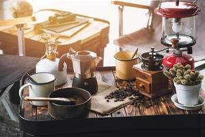 Cup Of Coffee, beans roating and Ingredients for making coffee  and accessories on the table wooden background. Coffee making concept photo