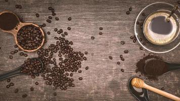 Brown coffee beans And a cup of hot coffee placed on a wooden table with honey. Wooden background with espresso and beans. Top view with copy space for your text. photo