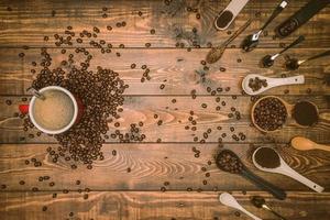 Brown coffee beans And a cup of hot coffee placed on a wooden table with honey. Wooden background and espresso and beans. Top view with copy space for your text. photo