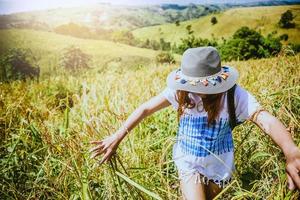 Asian women travel relax in the holiday. Stand natural touch mountain field. Thailand photo