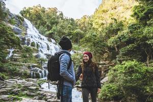 Travel relax to visit the waterfalls of couples. In the winter. at the waterfall mae ya chiangmai in thailand. travel nature. summer photo