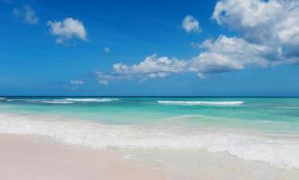 beautiful tropical paradise beach with white sand and coco palms on blue sea panorama. photo