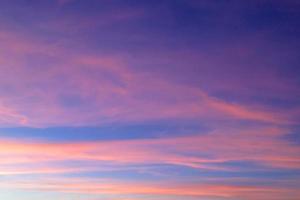 Brilliant orange sunset and sunrise beautiful over blue clouds with bright orange sun on a cool spring morning. photo