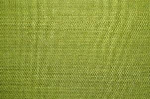 green fabric abstract water drop color folds fragment textured surface on canvas. photo