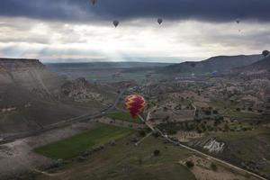 A balloons is flying over the valley in Cappadocia photo