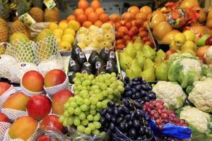 Green black red berries of grapes, mango, pears, apples, pineapple, melon are on the market for sale photo