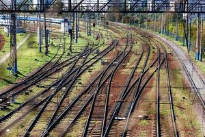 A network of multi-channel railways with a turn for the passage of electric trains, a view through the fence mesh. photo