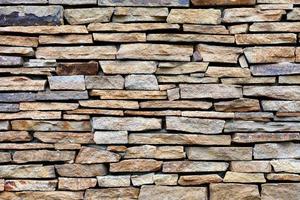 Sandstone stone wall mosaic, texture and background. photo