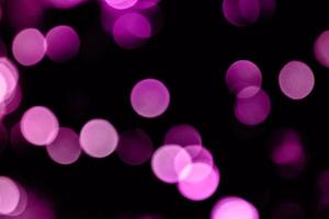 Fondo de desenfoque de color púrpura claro multicolor y fondo de círculo y efecto de luces de Navidad de desenfoque de círculo abstracto foto