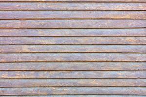 A concrete wall under the stylization of a wooden fence with smooth textured horizontal planks. photo