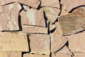 Large slabs of brown sandstone in harsh sunlight. photo