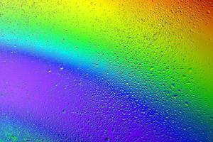 Drops of water on a rainbow background. photo