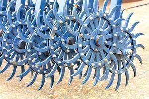Blue toothed metal harrow for field tillage. photo