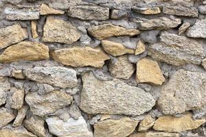 Stone wall from limestone stones. Abstract texture photo