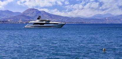 Silhouette of a marine yacht in the Corinthian bay against the backdrop of a mountain range in the morning haze. photo