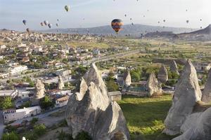 Dozens of balloons fly over the valleys in Cappadocia photo