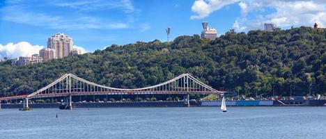 Panorama of the city of Kyiv, a view of the Dnipro River and a pedestrian bridge. photo