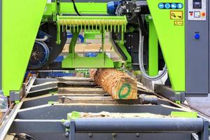 Woodworking, large logs in a modern sawmill. photo