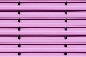 Pink metal protective fence with vertical guides. photo