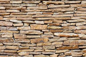 Rough masonry of the wall with orange old sandstone. photo