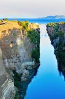 The narrow Corinth Canal in Greece, connecting the Aegean and Ionian Seas. Landscape on a sunny day.