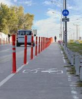 bike path in the park fenced with red road columns