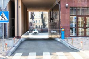 Automatic barrier for arched entry into the courtyard of the building. photo