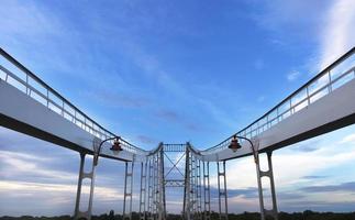 Symmetrical arches of the bridge are directed to the sky photo