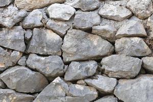 Stone wall from a large cobblestone sandstone close-up photo