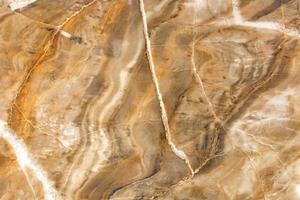 The surface, texture and background of beige and brown marble with cracks and waves. photo