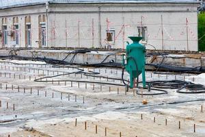 A construction sandblasting machine stands on a work platform for sandblasting of metal structures. photo