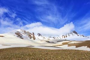 View of Mount Erciyas in central Turkey against a blue bright sky and white fog. photo