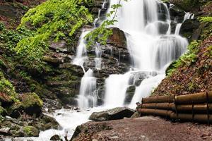 Carpathians. Powerful waterfall on a mountain river. Ukraine. photo