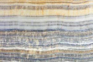 The surface, texture and background of striped marble with gray, brown and beige lines. photo