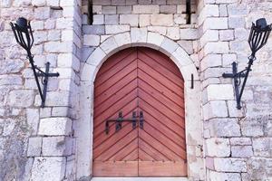 la entrada principal con portones de madera de la antigua fortaleza de piedra. foto