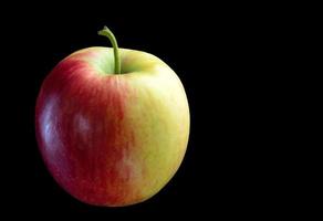 Yellow red apple on a black background. photo