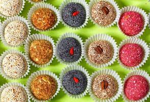 Handmade energy balls filled with various seeds in a paper basket. photo