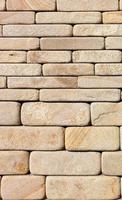 The wall is faced with hewn yellow sandstone of various thicknesses with rounded ribs. photo