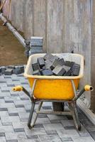 Blocks of paving slabs lie in a construction wheelbarrow and are brought to the workplace. photo