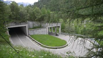 Serpentine mountain road and tunnel in the Alps video